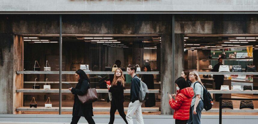 a group of people walking outside a store