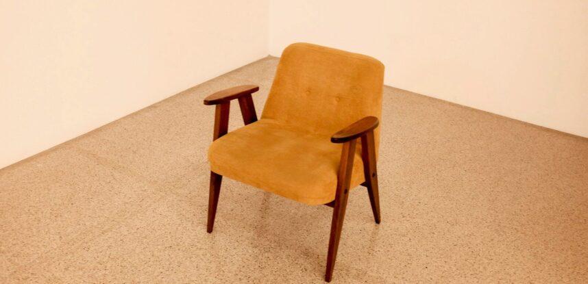 brown wooden framed beige padded chair